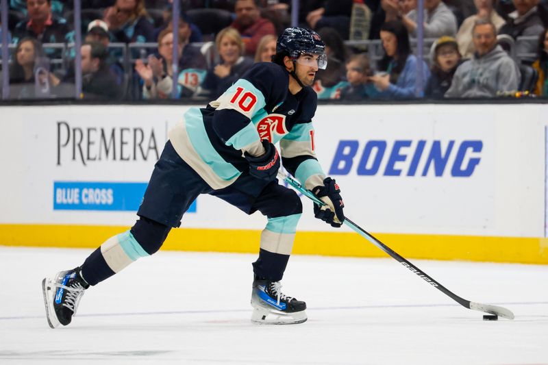 Mar 24, 2024; Seattle, Washington, USA; Seattle Kraken center Matty Beniers (10) skates with the puck against the Montreal Canadiens during the first period at Climate Pledge Arena. Mandatory Credit: Joe Nicholson-USA TODAY Sports