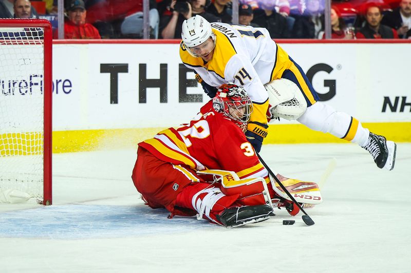 Nov 15, 2024; Calgary, Alberta, CAN; Calgary Flames goaltender Dustin Wolf (32) makes a save against Nashville Predators center Gustav Nyquist (14) during the first period at Scotiabank Saddledome. Mandatory Credit: Sergei Belski-Imagn Images