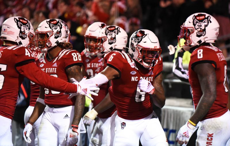 Oct 30, 2021; Raleigh, North Carolina, USA;  North Carolina State Wolfpack running back Trent Pennix (6) celebrates a touchdown during the second half against the Louisville Cardinals at Carter-Finley Stadium.  The Wolfpack won 28-13.  Mandatory Credit: Rob Kinnan-USA TODAY Sports