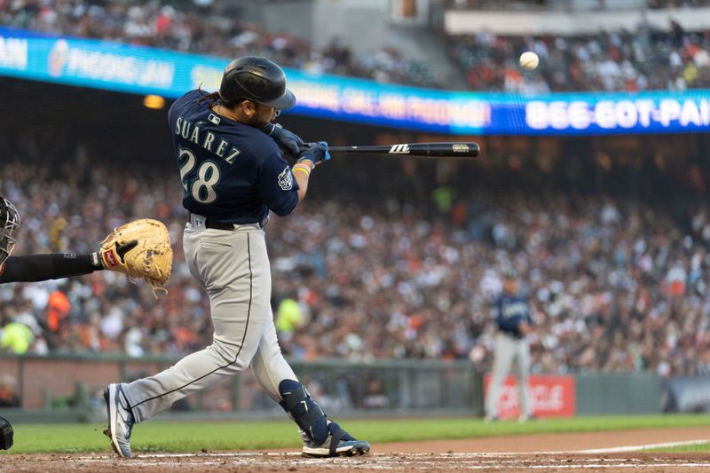 Jul 3, 2023; San Francisco, California, USA;  Seattle Mariners third baseman Eugenio Suarez (28) hits a single during the fourth inning against the San Francisco Giants at Oracle Park. Mandatory Credit: Stan Szeto-USA TODAY Sports