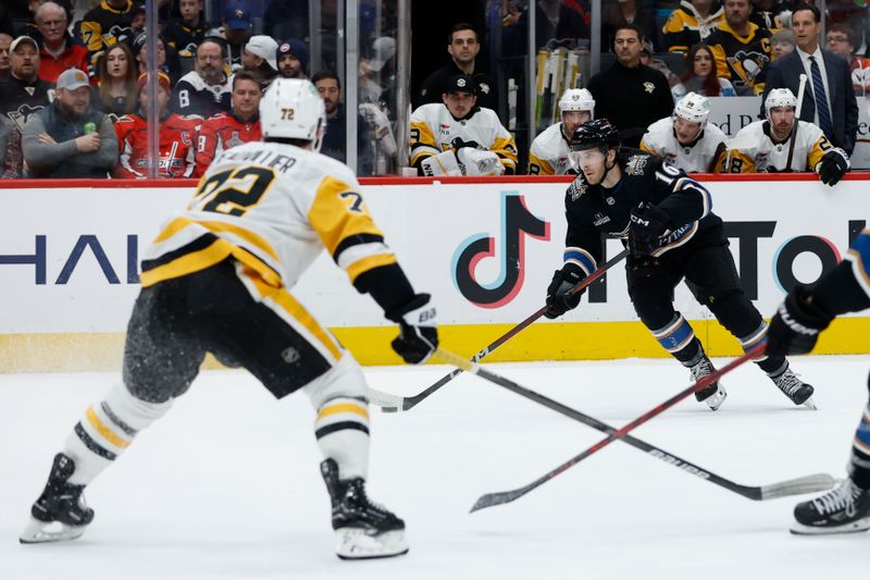 Jan 18, 2025; Washington, District of Columbia, USA; Washington Capitals right wing Taylor Raddysh (16) skates with the puck as Pittsburgh Penguins left wing Anthony Beauvillier (72) defends in the first period at Capital One Arena. Mandatory Credit: Geoff Burke-Imagn Images