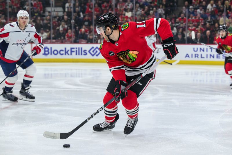 Dec 10, 2023; Chicago, Illinois, USA; Chicago Blackhawks right wing Taylor Raddysh (11) skates with the puck against the Washington Capitals during the first period at the United Center. Mandatory Credit: Daniel Bartel-USA TODAY Sports