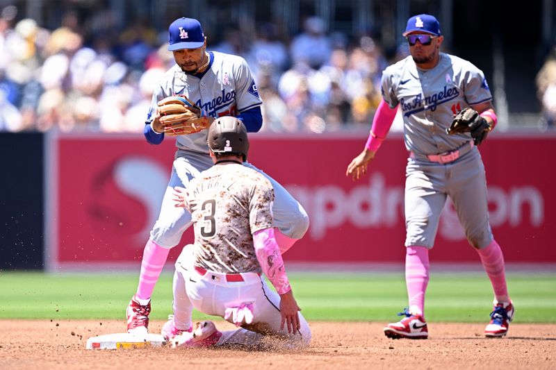 May 12, 2024; San Diego, California, USA; Los Angeles Dodgers shortstop Mookie Betts (50) forces out San Diego Padres center fielder Jackson Merrill (3) at second base during the second inning at Petco Park. Mandatory Credit: Orlando Ramirez-USA TODAY Sports