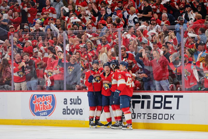 May 24, 2025; Sunrise, Florida, USA; Florida Panthers center Jesper Boqvist (70) celebrates with teammates after a goal during the third period against the Carolina Hurricanes in game three of the Eastern Conference Final of the 2025 Stanley Cup Playoffs at Amerant Bank Arena. Mandatory Credit: Sam Navarro-Imagn Images