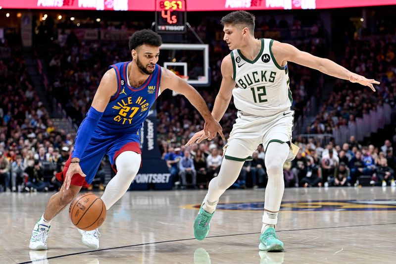 DENVER, CO - MARCH 25:  Jamal Murray #27 of the Denver Nuggets is covered by Grayson Allen #12 of the Milwaukee Bucks in a game at Ball Arena on March 25, 2023 in Denver, Colorado. NOTE TO USER: User expressly acknowledges and agrees that, by downloading and or using this photograph, User is consenting to the terms and conditions of the Getty Images License Agreement. (Photo by Dustin Bradford/Getty Images)