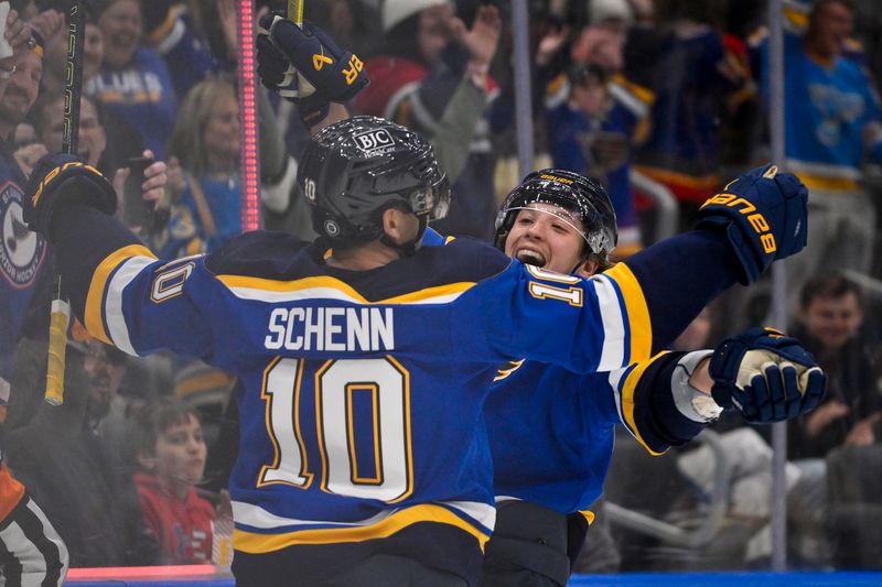 Nov 12, 2024; St. Louis, Missouri, USA;  St. Louis Blues center Brayden Schenn (10) celebrates with left wing Jake Neighbours (63) after scoring against the Boston Bruins during the second period at Enterprise Center. Mandatory Credit: Jeff Curry-Imagn Images