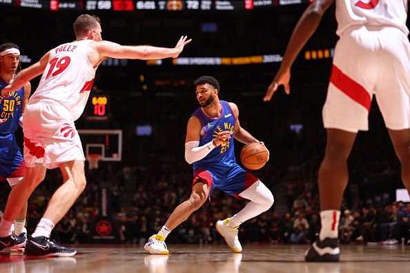 TORONTO, CANADA - DECEMBER 20: Jamal Murray #27 of the Denver Nuggets handles the ball during the game against the Toronto Raptors on December 20, 2023 at the Scotiabank Arena in Toronto, Ontario, Canada.  NOTE TO USER: User expressly acknowledges and agrees that, by downloading and or using this Photograph, user is consenting to the terms and conditions of the Getty Images License Agreement.  Mandatory Copyright Notice: Copyright 2023 NBAE (Photo by Vaughn Ridley/NBAE via Getty Images)