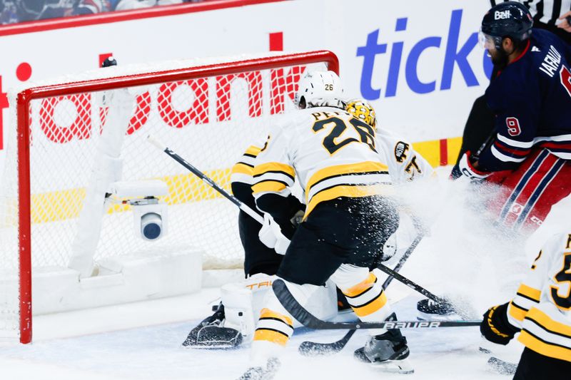 Dec 11, 2025; Winnipeg, Manitoba, CAN;  Winnipeg Jets forward Alex Iafallo (9) scores on Boston Bruins goalie Joonas Jorpisalo (70) during the first period at Canada Life Centre. Mandatory Credit: Terrence Lee-Imagn Images