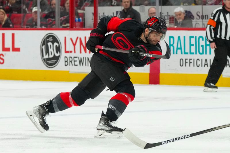 Mar 11, 2023; Raleigh, North Carolina, USA;  Carolina Hurricanes defenseman Shayne Gostisbehere (41) takes a shot against the Vegas Golden Knights during the first period at PNC Arena. Mandatory Credit: James Guillory-USA TODAY Sports