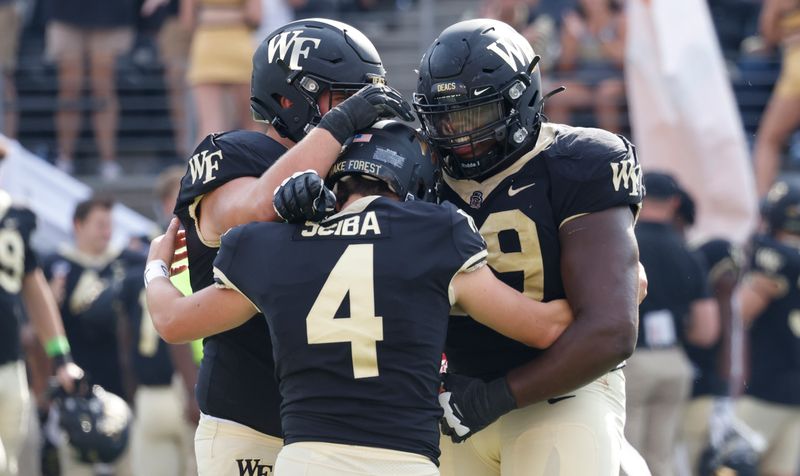 Oct 2, 2021; Winston-Salem, North Carolina, USA;  Wake Forest Demon Deacons place kicker Nick Sciba (4) celebrates with Wake Forest Demon Deacons offensive lineman Luke Petitbon (left) and defensive lineman Jonathan Saklad (59) after he kicks the game winning field goal  during the second half against the Louisville Cardinals at Truist Field. Mandatory Credit: Reinhold Matay-USA TODAY Sports