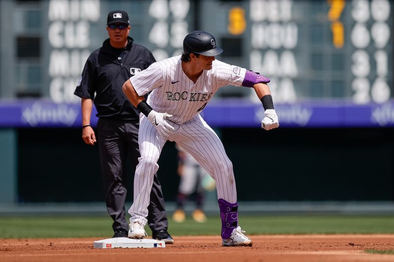 Apr 30, 2025; Denver, Colorado, USA; Colorado Rockies first baseman Michael Toglia (4) reacts from second on a double in the second inning against the Atlanta Braves at Coors Field. Mandatory Credit: Isaiah J. Downing-Imagn Images