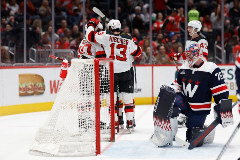 Feb 20, 2024; Washington, District of Columbia, USA; New Jersey Devils right wing Alexander Holtz (10) celebrates with teammates after scoring a goal on Washington Capitals goaltender Charlie Lindgren (79) in the first period at Capital One Arena. Mandatory Credit: Geoff Burke-USA TODAY Sports