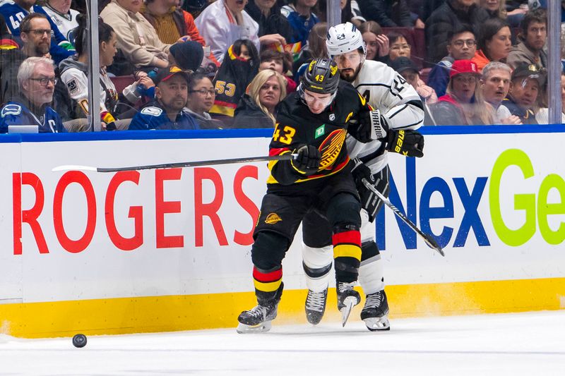 Mar 25, 2024; Vancouver, British Columbia, CAN;  Los Angeles Kings forward Phillip Danault (24) checks Vancouver Canucks defenseman Quinn Hughes (43) in the second period at Rogers Arena. Mandatory Credit: Bob Frid-USA TODAY Sports