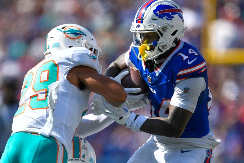 Buffalo Bills wide receiver Stefon Diggs, right, breaks away from Miami Dolphins safety Brandon Jones (29) on his way to a touchdown during the first half of an NFL football game in Orchard Park, N.Y., Sunday, Oct. 1, 2023. (AP Photo/Adrian Kraus)