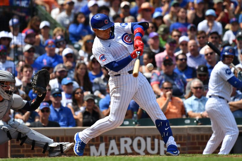 Aug 22, 2024; Chicago, Illinois, USA; Chicago Cubs catcher Miguel Amaya (9) hits a grand slam during the second inning against the Detroit Tigers at Wrigley Field. Mandatory Credit: Patrick Gorski-USA TODAY Sports