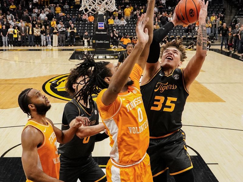 Feb 20, 2024; Columbia, Missouri, USA; Missouri Tigers forward Noah Carter (35) shoots as Tennessee Volunteers forward Jonas Aidoo (0) defends during the first half at Mizzou Arena. Mandatory Credit: Denny Medley-USA TODAY Sports