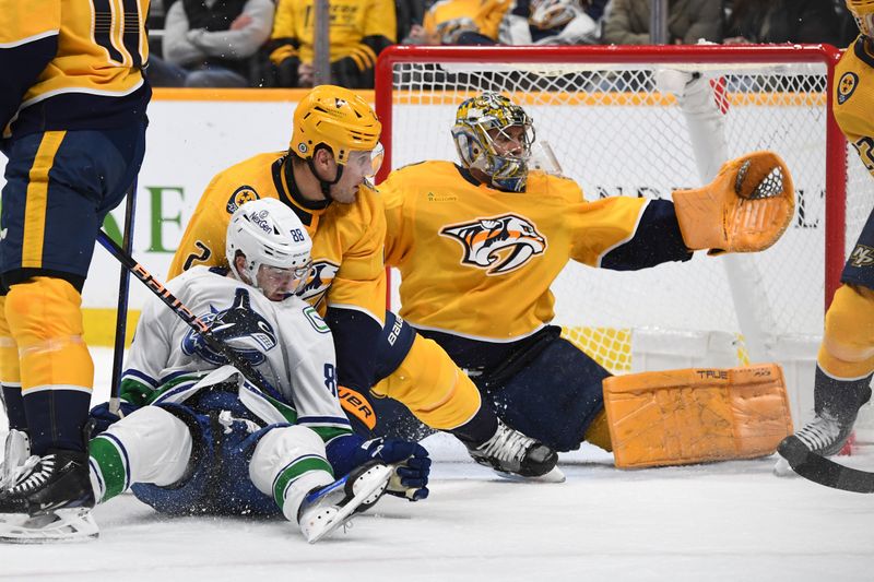 Dec 19, 2023; Nashville, Tennessee, USA; Nashville Predators goaltender Juuse Saros (74) makes a save in traffic during the second period against the Vancouver Canucks at Bridgestone Arena. Mandatory Credit: Christopher Hanewinckel-USA TODAY Sports