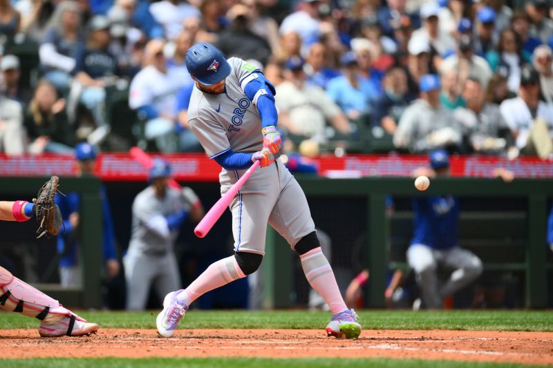 May 11, 2025; Seattle, Washington, USA; Toronto Blue Jays designated hitter George Springer (4) hits a 3-run home run against the Seattle Mariners during the fifth inning at T-Mobile Park. Mandatory Credit: Steven Bisig-Imagn Images