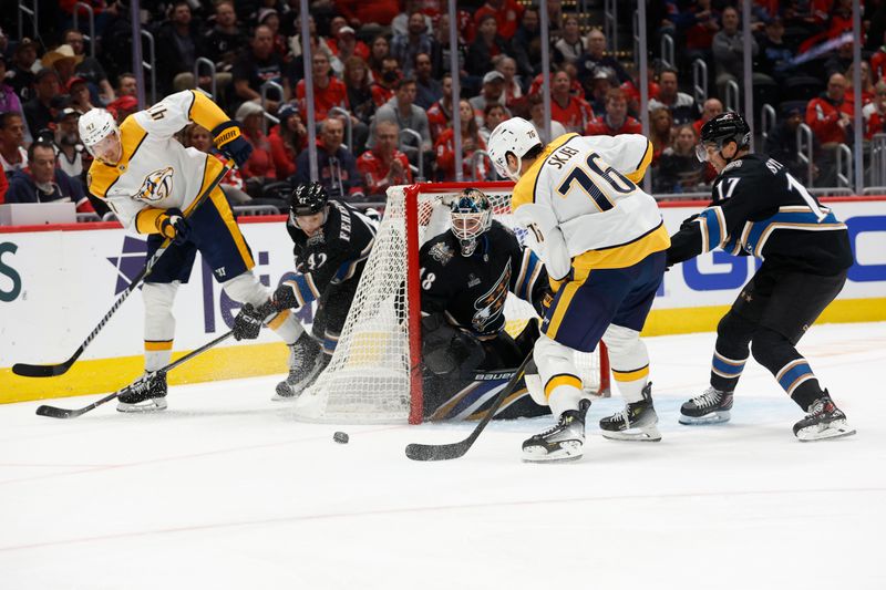 Nov 6, 2024; Washington, District of Columbia, USA; Nashville Predators right wing Michael McCarron (47) passes the puck to Nashville Predators defenseman Brady Skjei (76) infant of Washington Capitals goaltender Logan Thompson (48) in the second period at Capital One Arena. Mandatory Credit: Geoff Burke-Imagn Images