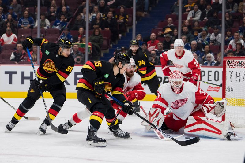 Feb 13, 2023; Vancouver, British Columbia, CAN; Vancouver Canucks forward Dakota Joshua (81) and forward Sheldon Dries (15) look for the rebound as Detroit Red Wings goalie Ville Husso (35) makes a save in the first period at Rogers Arena. Mandatory Credit: Bob Frid-USA TODAY Sports