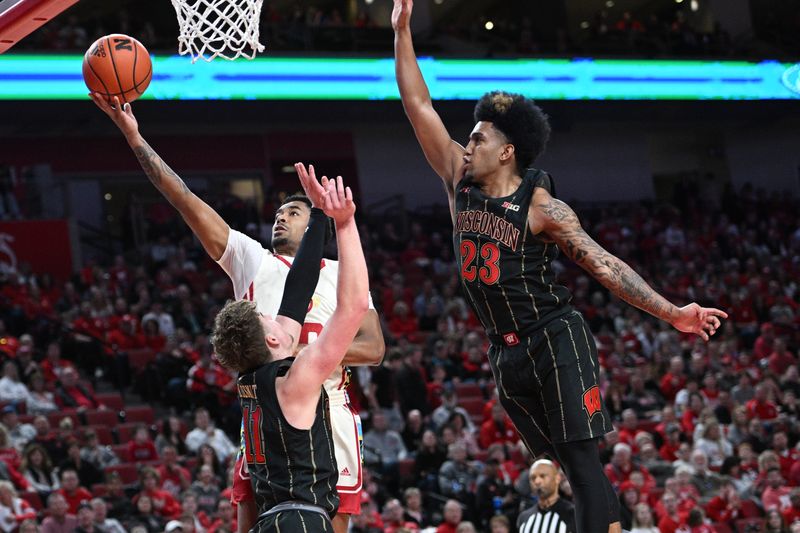 Feb 11, 2023; Lincoln, Nebraska, USA;  Nebraska Cornhuskers guard Jamarques Lawrence (10) scores over Wisconsin Badgers guard Max Klesmit (11) in the first half at Pinnacle Bank Arena. Mandatory Credit: Steven Branscombe-USA TODAY Sports