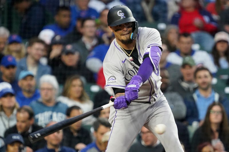 May 28, 2025; Chicago, Illinois, USA; Colorado Rockies designated hitter Orlando Arcia (8) hits a single against the Chicago Cubs during the third inning at Wrigley Field. Mandatory Credit: David Banks-Imagn Images