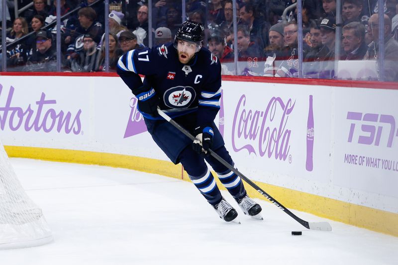 Dec 3, 2024; Winnipeg, Manitoba, CAN;  Winnipeg Jets forward Adam Lowry (17) skates behind the St. Louis Blues net during the second period at Canada Life Centre. Mandatory Credit: Terrence Lee-Imagn Images