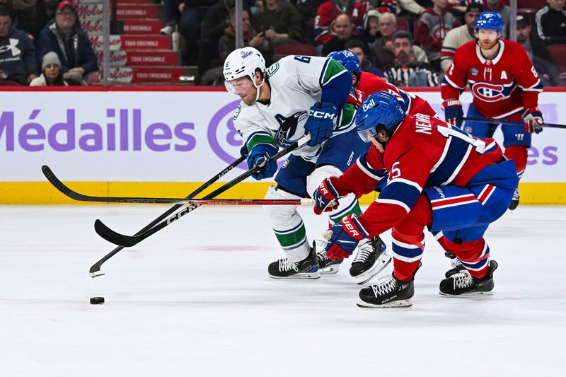 Nov 12, 2023; Montreal, Quebec, CAN; Vancouver Canucks right wing Brock Boeser (6) plays the puck against Montreal Canadiens center Alex Newhook (15) during the third period at Bell Centre. Mandatory Credit: David Kirouac-USA TODAY Sports