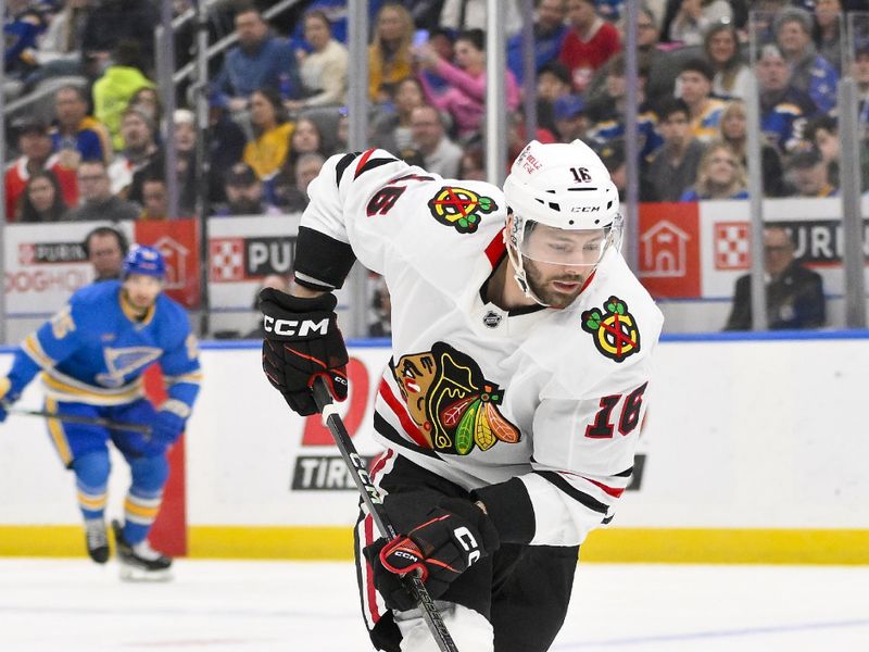 Mar 22, 2025; St. Louis, Missouri, USA;  Chicago Blackhawks center Jason Dickinson (16) controls the puck against the St. Louis Blues during the first period at Enterprise Center. Mandatory Credit: Jeff Curry-Imagn Images