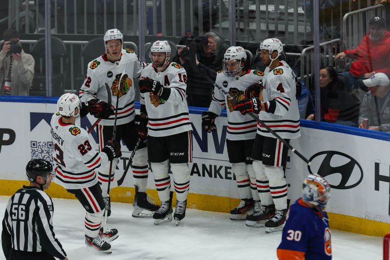 Apr 2, 2024; Elmont, New York, USA; Chicago Blackhawks center Jason Dickinson (16) celebrates his goal against the New York Islanders during the first period at UBS Arena. Mandatory Credit: Thomas Salus-USA TODAY Sports