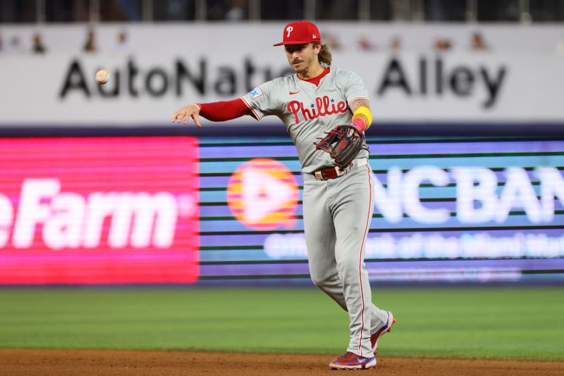 Sep 5, 2024; Miami, Florida, USA; Philadelphia Phillies second baseman Bryson Stott (5) throws to first base to retire Miami Marlins left fielder Kyle Stowers (not pictured) during the fifth inning at loanDepot Park. Mandatory Credit: Sam Navarro-Imagn Images