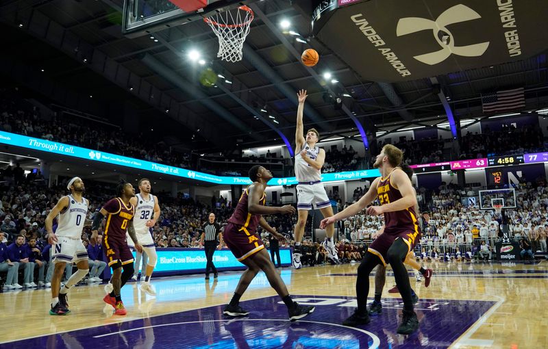 Mar 9, 2024; Evanston, Illinois, USA; Northwestern Wildcats guard Ryan Langborg (5) scores on Minnesota Golden Gophers forward Pharrel Payne (21) during the second half at Welsh-Ryan Arena. Mandatory Credit: David Banks-USA TODAY Sports