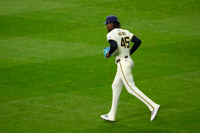 Oct 14, 2025; Milwaukee, Wisconsin, USA; Milwaukee Brewers pitcher Abner Uribe (45) runs toward the mound after being called in to pitch against the Los Angeles Dodgers in the sixth inning during game two of the NLCS round for the 2025 MLB playoffs at American Family Field. Mandatory Credit: Michael McLoone-Imagn Images