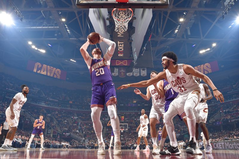 CLEVELAND, OH - MARCH 11:  Jusuf Nurkic #20 of the Phoenix Suns handles the ball during the game against the Cleveland Cavaliers on March 11, 2024 at Rocket Mortgage FieldHouse in Cleveland, Ohio. NOTE TO USER: User expressly acknowledges and agrees that, by downloading and/or using this Photograph, user is consenting to the terms and conditions of the Getty Images License Agreement. Mandatory Copyright Notice: Copyright 2024 NBAE (Photo by David Liam Kyle/NBAE via Getty Images)