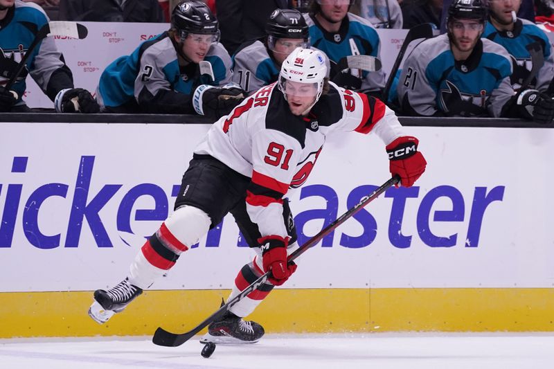 Oct 30, 2025; San Jose, California, USA;  New Jersey Devils forward Alexander Holtz (91) advances the puck against the San Jose Sharks in the first period at SAP Center at San Jose. Mandatory Credit: David Gonzales-Imagn Images