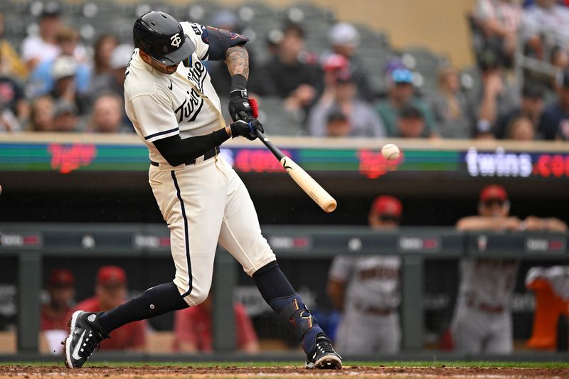 Aug 6, 2023; Minneapolis, Minnesota, USA;  Minnesota Twins infielder Carlos Correa (4) collects his 600th and 601st career RBI on a single against the Arizona Diamondbacks during the sixth inning at Target Field. Mandatory Credit: Nick Wosika-USA TODAY Sports