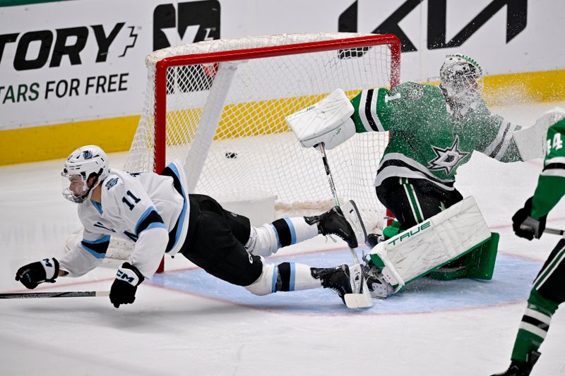 Apr 12, 2025; Dallas, Texas, USA; Utah Hockey Club right wing Dylan Guenther (11) is tripped up in front of Dallas Stars goaltender Casey DeSmith (1) during the second period at the American Airlines Center. Mandatory Credit: Jerome Miron-Imagn Images