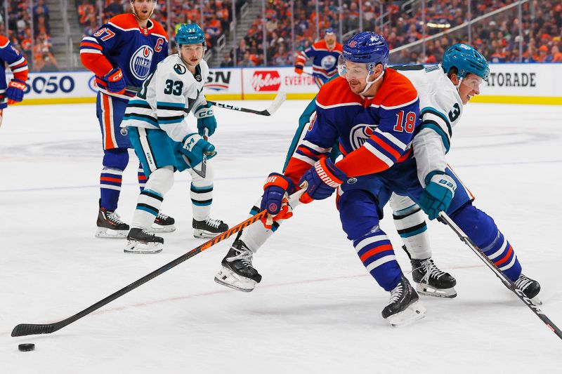 Apr 15, 2024; Edmonton, Alberta, CAN; Edmonton Oilers forward Zach Hyman (18) protects the puck from from San Jose Sharks defensemen Henry Thrun (3) during the first period at Rogers Place. Mandatory Credit: Perry Nelson-USA TODAY Sports