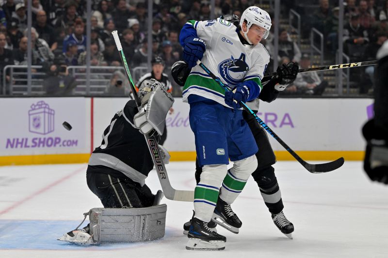 Nov 29, 2025; Los Angeles, California, USA;  Los Angeles Kings goaltender Anton Forsberg (31) makes a save off a deflection by Vancouver Canucks center David Kampf (64) in the first period at Crypto.com Arena. Mandatory Credit: Jayne Kamin-Oncea-Imagn Images