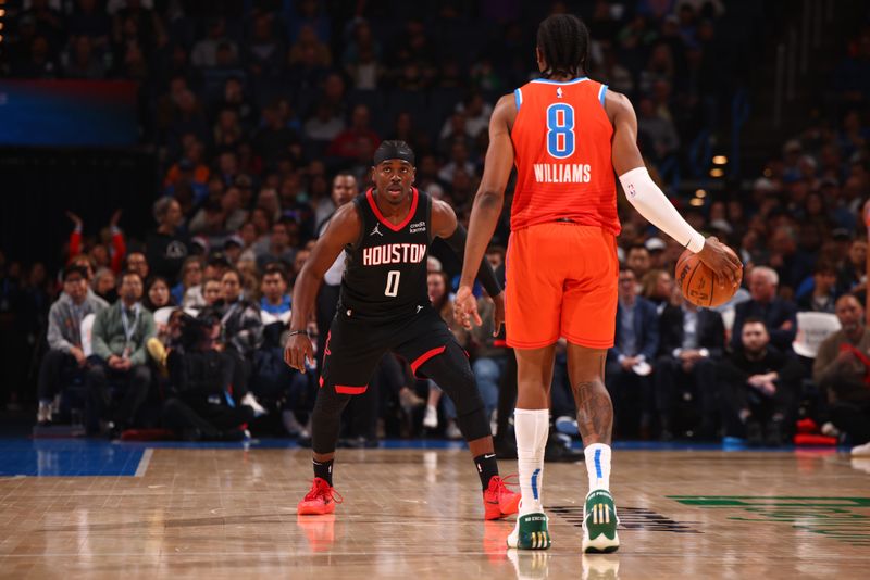 OKLAHOMA CITY, OK - MARCH 27:  Aaron Holiday #0 of the Houston Rockets plays defense against Jalen Williams #8 of the Oklahoma City Thunder on March 27, 2024 at Paycom Arena in Oklahoma City, Oklahoma. NOTE TO USER: User expressly acknowledges and agrees that, by downloading and or using this photograph, User is consenting to the terms and conditions of the Getty Images License Agreement. Mandatory Copyright Notice: Copyright 2024 NBAE (Photo by Zach Beeker/NBAE via Getty Images)