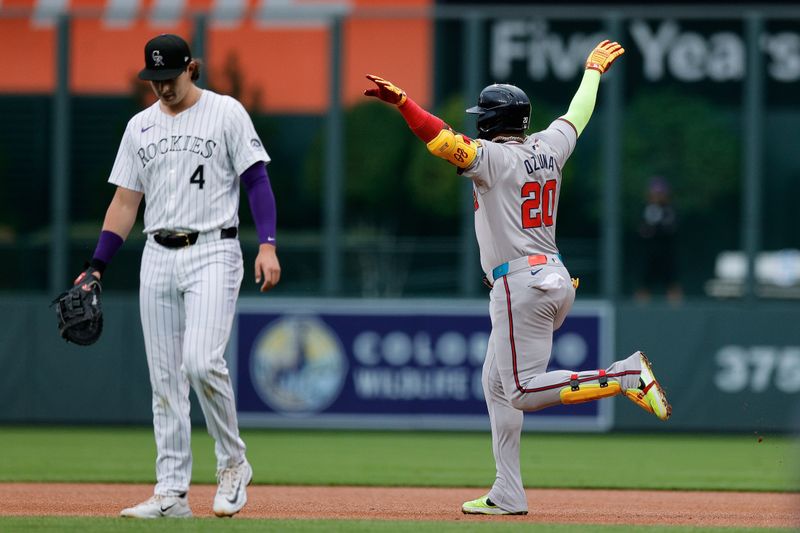 Aug 9, 2024; Denver, Colorado, USA; Atlanta Braves designated hitter Marcell Ozuna (20) celebrates his home run as he jogs past Colorado Rockies first baseman Michael Toglia (4) in the first inning at Coors Field. Mandatory Credit: Isaiah J. Downing-USA TODAY Sports