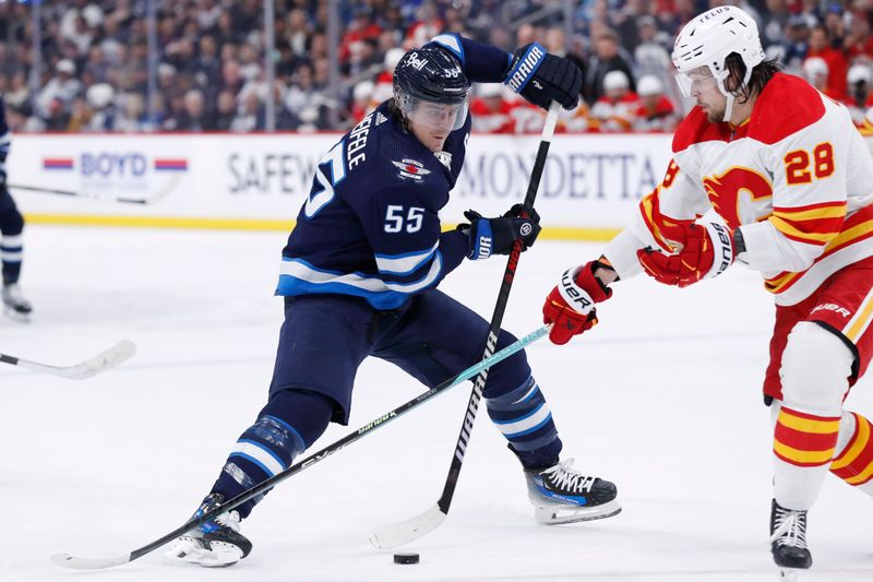 Apr 4, 2024; Winnipeg, Manitoba, CAN; Winnipeg Jets center Mark Scheifele (55) is checked by Calgary Flames defenseman Nikita Okhotiuk (28) in the second period at Canada Life Centre. Mandatory Credit: James Carey Lauder-USA TODAY Sports