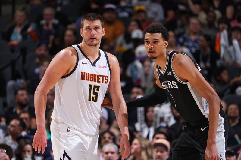 SAN ANTONIO, TX - APRIL 12: Nikola Jokic #15 of the Denver Nuggets plays defense against Victor Wembanyama #1 of the San Antonio Spurs during the game  on April 12, 2024 at the Frost Bank Center in San Antonio, Texas. NOTE TO USER: User expressly acknowledges and agrees that, by downloading and or using this photograph, user is consenting to the terms and conditions of the Getty Images License Agreement. Mandatory Copyright Notice: Copyright 2024 NBAE (Photos by Garrett Ellwood/NBAE via Getty Images)