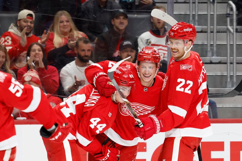 Nov 18, 2025; Detroit, Michigan, USA; Detroit Red Wings center Nate Danielson (29) receives congratulations from defenseman Axel Sandin-Pellikka (44) and center Mason Appleton (22) after scoring in the second period against the Seattle Kraken at Little Caesars Arena. Mandatory Credit: Rick Osentoski-Imagn Images