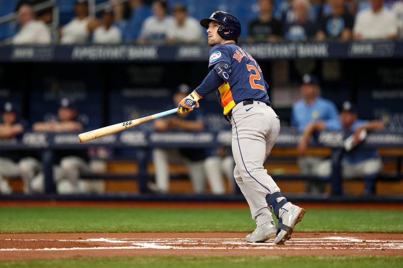 Aug 12, 2024; St. Petersburg, Florida, USA; Houston Astros third baseman Alex Bregman (2) hits a home run against the Tampa Bay Rays in the first inning  at Tropicana Field. Mandatory Credit: Nathan Ray Seebeck-USA TODAY Sports