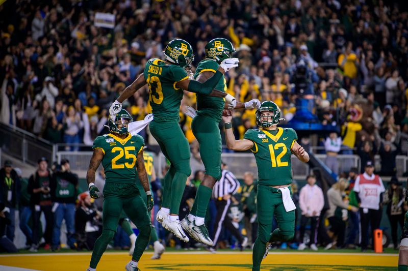 Nov 16, 2019; Waco, TX, USA; Baylor Bears running back Trestan Ebner (25) and wide receiver R.J. Sneed (13) and wide receiver Denzel Mims (5) and quarterback Charlie Brewer (12) celebrate scoring a touchdown against the Oklahoma Sooners during the second quarter at McLane Stadium. Mandatory Credit: Jerome Miron-USA TODAY Sports