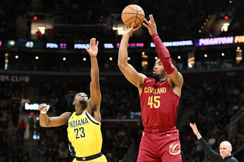 CLEVELAND, OHIO - APRIL 12: Donovan Mitchell #45 of the Cleveland Cavaliers shoots a three-point basket against Aaron Nesmith #23 of the Indiana Pacers during the first half at Rocket Mortgage Fieldhouse on April 12, 2024 in Cleveland, Ohio. NOTE TO USER: User expressly acknowledges and agrees that, by downloading and or using this photograph, User is consenting to the terms and conditions of the Getty Images License Agreement. (Photo by Nick Cammett/Getty Images)