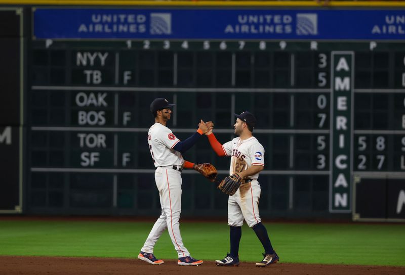 Jul 11, 2024; Houston, Texas, USA; Houston Astros shortstop Jeremy Pena (3) and second baseman Jose Altuve (27) celebrate the win against the Miami Marlins at Minute Maid Park. Mandatory Credit: Thomas Shea-USA TODAY Sports