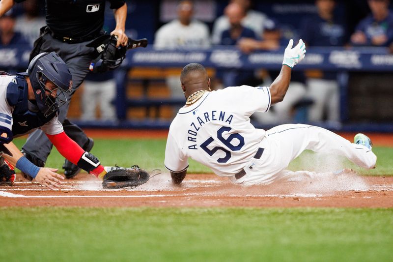 May 21, 2024; St. Petersburg, Florida, USA;  Tampa Bay Rays outfielder Randy Arozarena (56) scores a run against the Boston Red Sox in the first inning at Tropicana Field. Mandatory Credit: Nathan Ray Seebeck-USA TODAY Sports