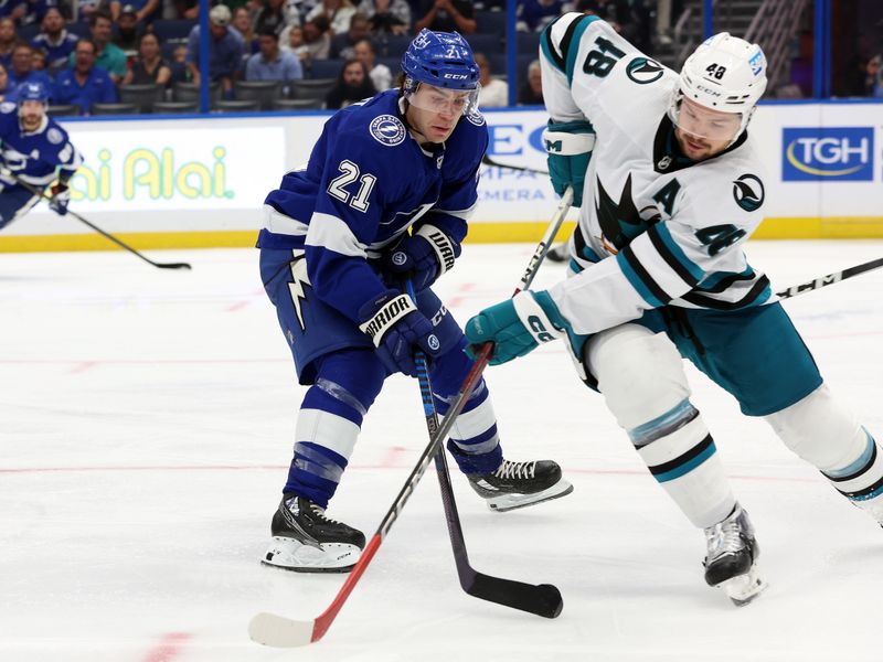 Oct 26, 2023; Tampa, Florida, USA; Tampa Bay Lightning center Brayden Point (21) defends San Jose Sharks right wing Filip Zadina (18) during the third period at Amalie Arena. Mandatory Credit: Kim Klement Neitzel-USA TODAY Sports